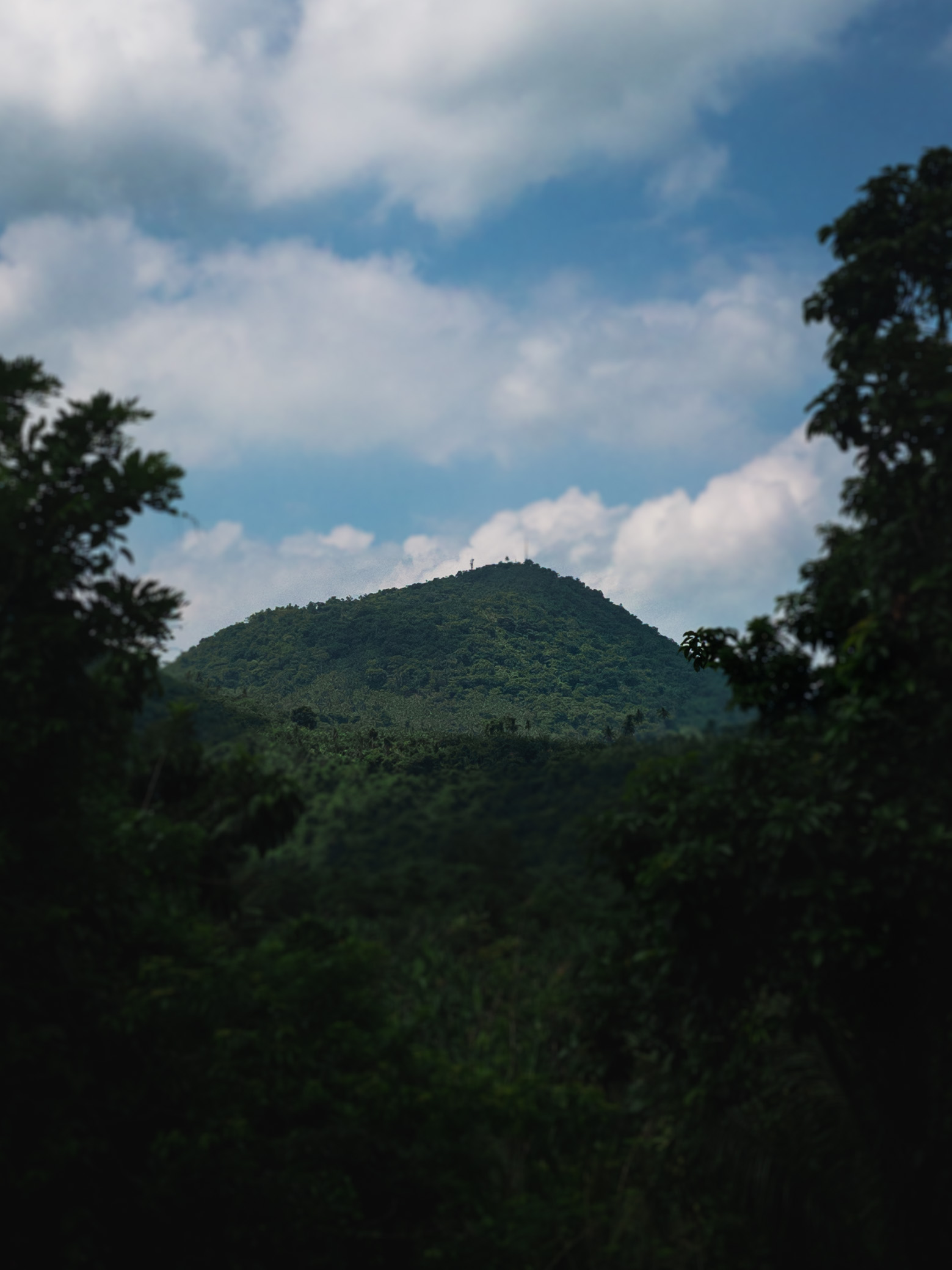 A photo of Mt. Banahaw's peak from the steep Calauan–San Pablo Road, taken during my first multi-day walk in 2022, using the Lightroom mobile app camera in the iPhone 11 Pro Max. Mt. Banahaw